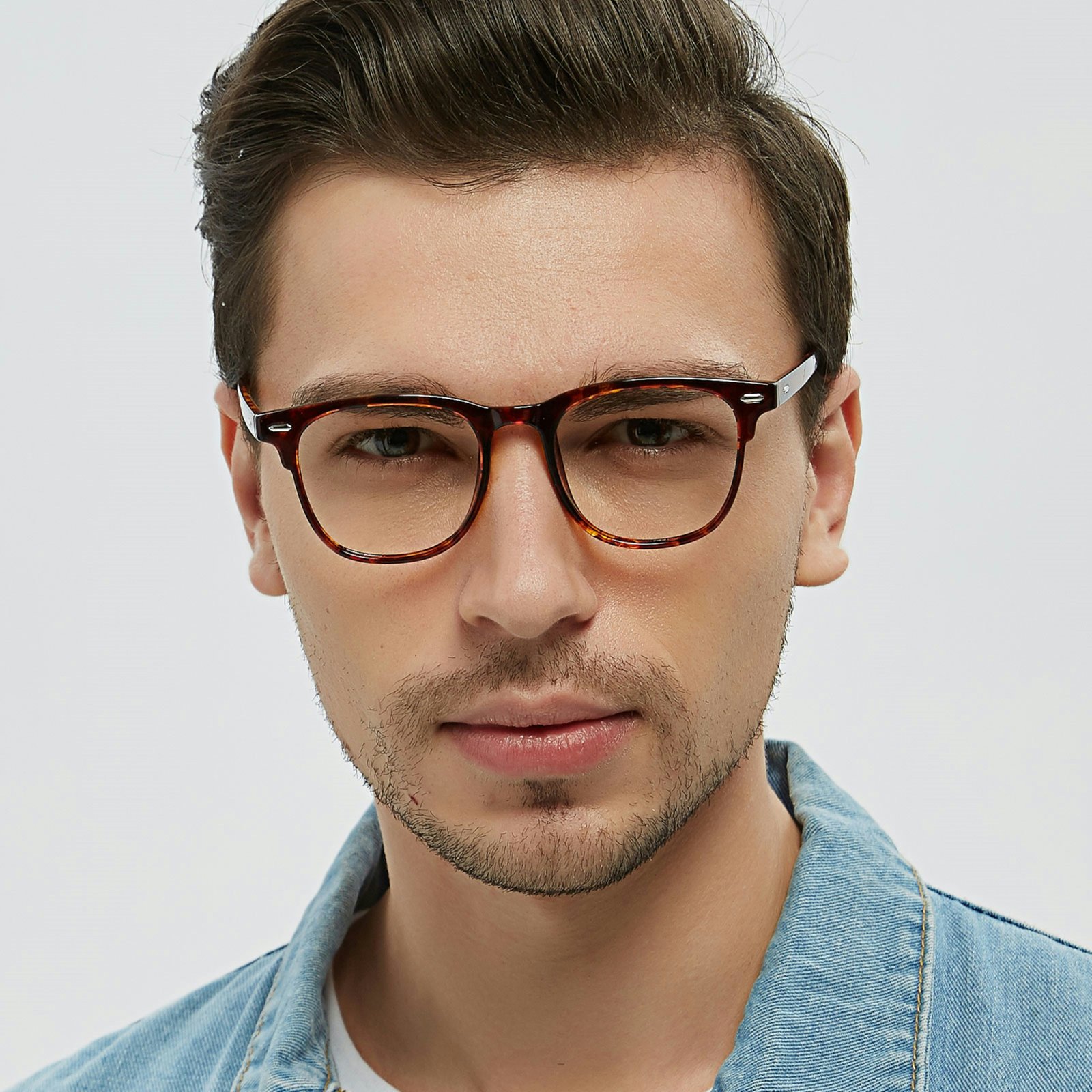 A man wearing glasses and a denim jacket